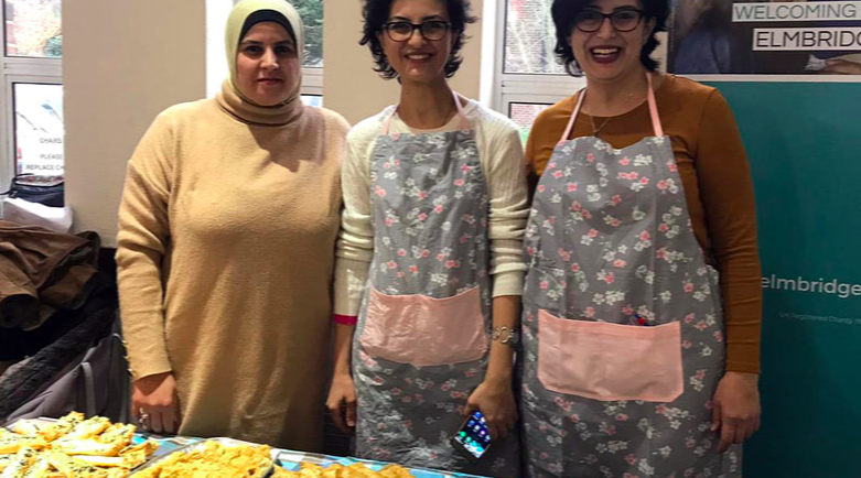Picture of three women serving food at a fundraising event for Elmbridge CAN © Elmbridge CAN